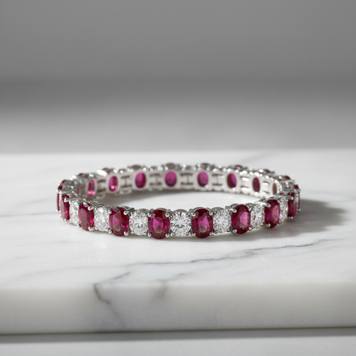 Ruby and diamond tennis bracelet on white marble